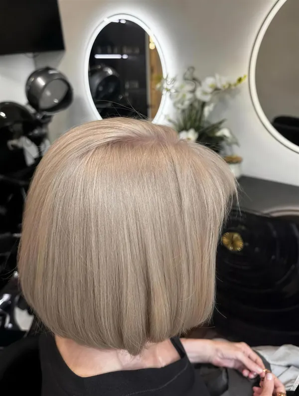 Sleek blonde bob, cut and styled