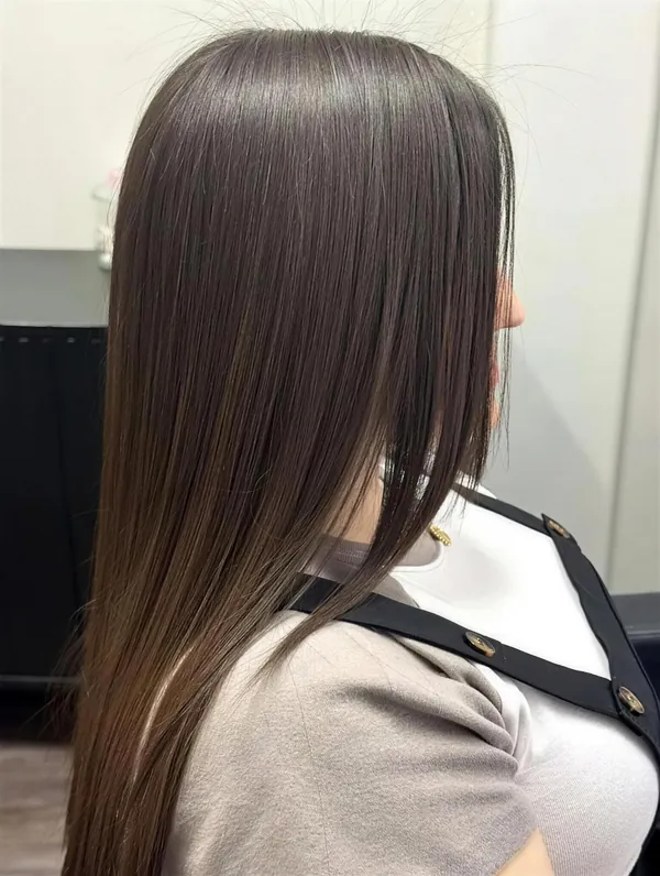 Smooth, glossy brunette hair after a keratin treatment